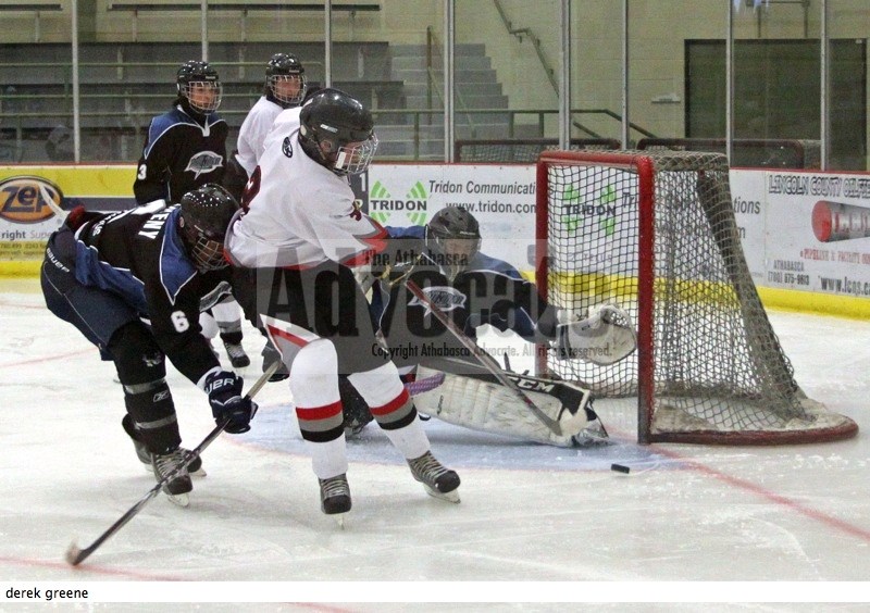 North Central AA Bulls&#8217; Derek Greene fires a shot that eludes the Slave Lake Thunder goalie, but not the goal post during the third period of their game on Saturday