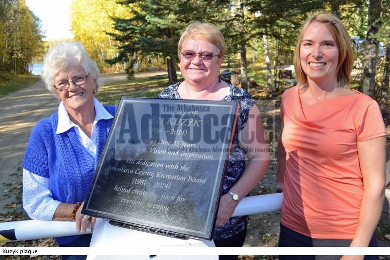 (l-r) Anne Kuzyk, Athabasca County Reeve Doris Splane and Athabasca County Recreation Board chair Juanita Marois stand next to the plaque dedicated to the work and memory of