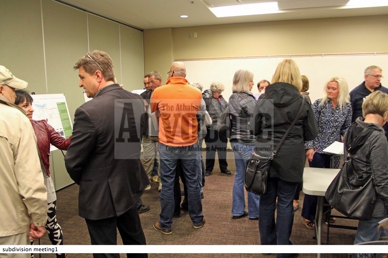 Concerned residents talk to representatives of the developer and town staff about the proposed subdivision.