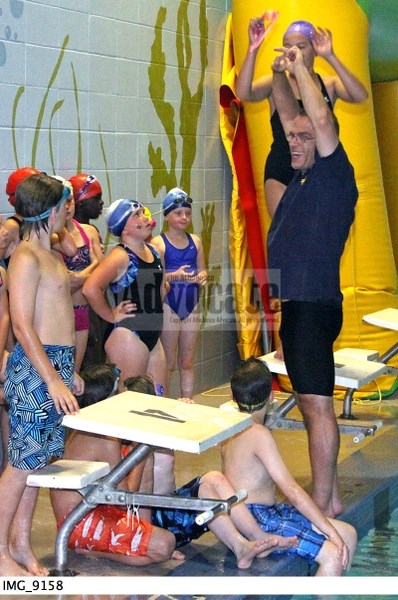 Head coach Steve Splinter gives some instructions on proper technique to some of the non-competitive program swimmers.