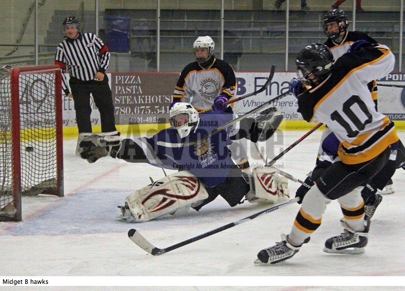 Josh Payuk (10) of the Athabasca Midget B Winter Hawks watches his shot tickle the twine behind the Fox Creek goaltender for one of the team&#8217;s second period goals in