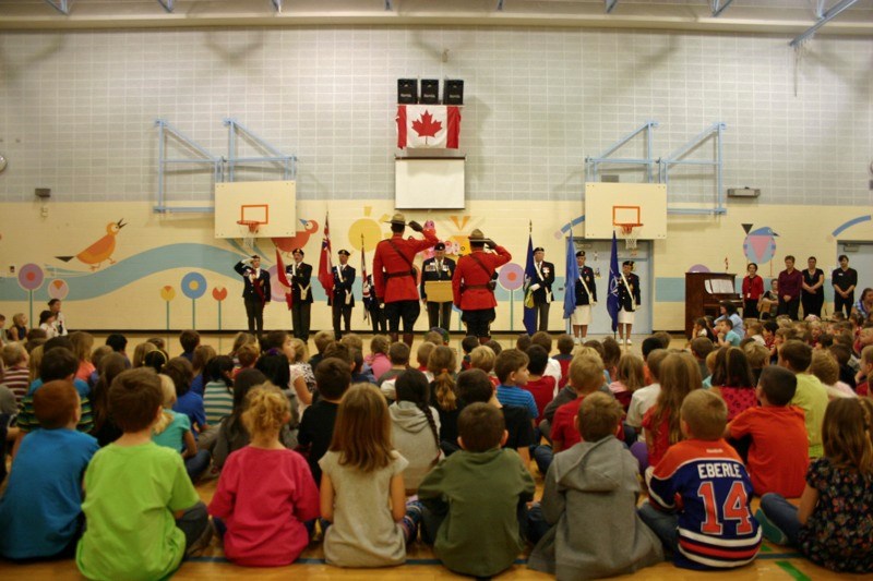 Whispering Hills Primary School students observe Remembrance Day along with members of the Athabasca RCMP and Athabasca Royal Canadian Legion Members during a ceremony at the 