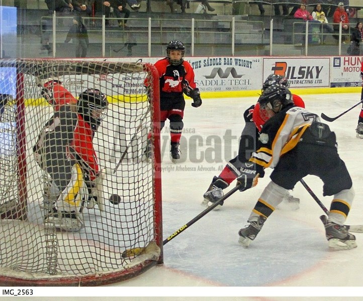Athabasca&#8217;s Noah White (7) bangs home a rebound past the Mayerthorpe goalie to take the lead in the second period.