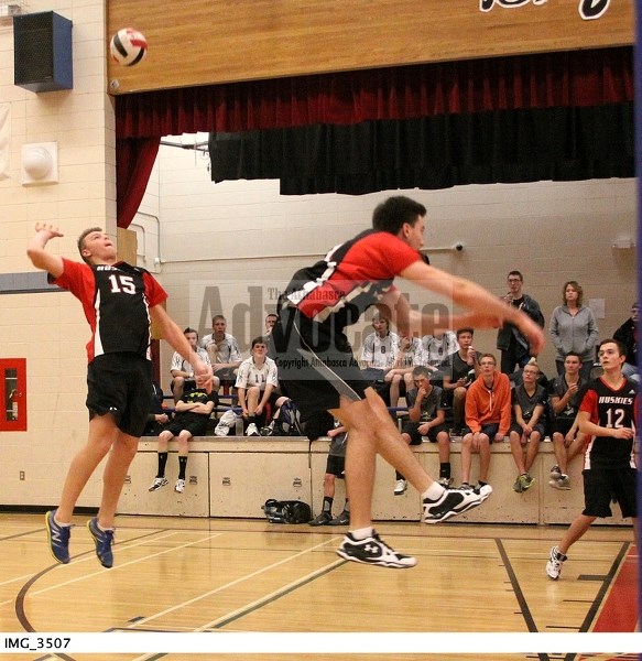 Boyle&#8217;s Dallan Bencharsky (15) goes for this back row attack while teammate Rylan Tkachuk (16) fakes the spike as Noah Bergmann (12) watches during a match against