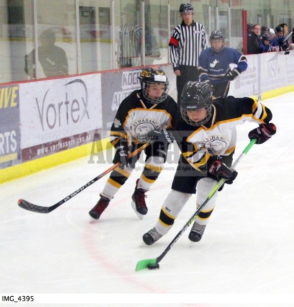 Athabasca Storm Hawks Jenna Kociuba carries the puck out of the corner and gets ready to turn up ice with teammate Owen Cormier close behind during their 10-1 loss to Wabasca 