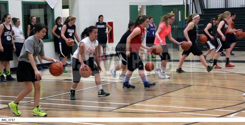 The girls go through some dribbling drills during tryouts for the senior girls team last week.