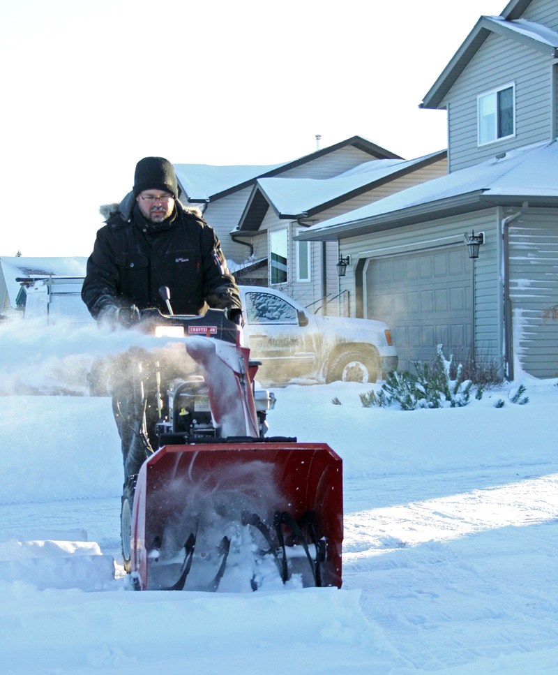 Paul Deveau takes on the minus 30 degree temperatures early Saturday morning with his snowblower so the driveway of his Cornwall area home is as clean as the recently plowed