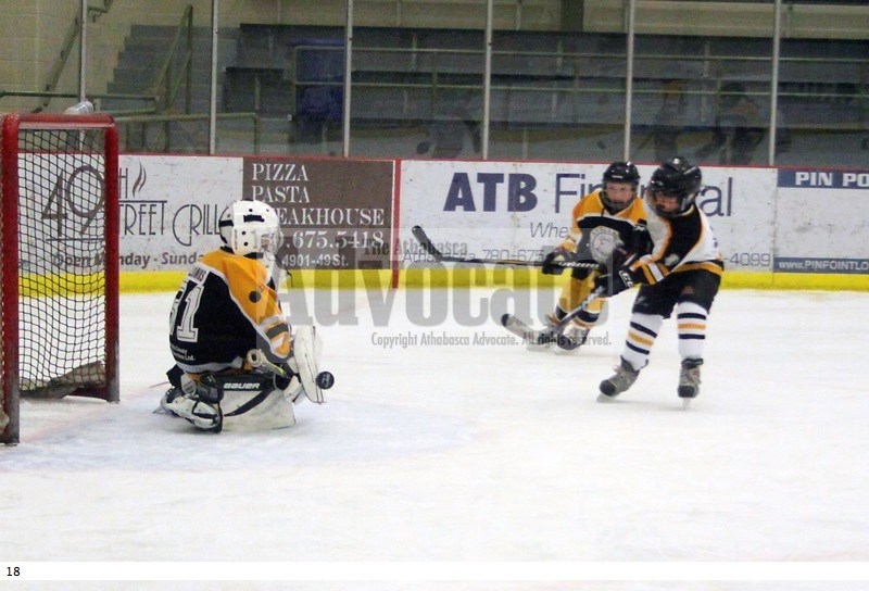Athabasca Atom B Seahawks Jesse Li (right) has this shot stopped by Athabasca Storm Hawks goalie Hardy Loomis during second period play Saturday at the Multiplex.