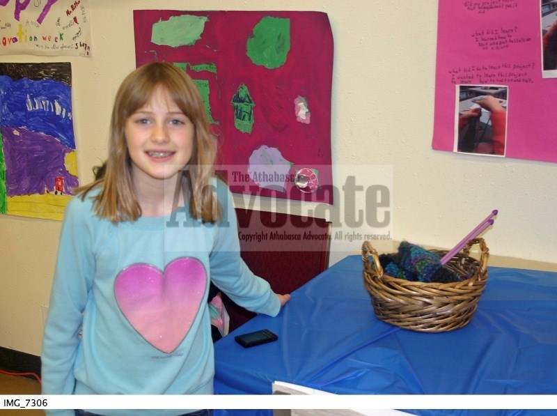 Holly Mccullagh shows the scarf she knitted during the week.