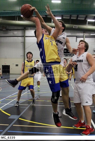 Edwin Parr Composite senior boys Rene Desjardins (7) makes a great block, and avoids the foul, as the Drayton Valley player drives to the hoop as teammate Justin Kwasney (4)