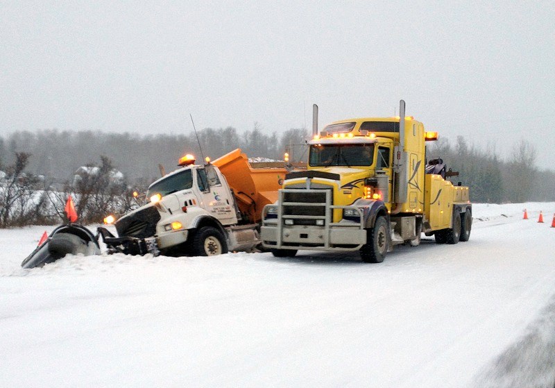 A snowplow was one of the many vehicles that found the road conditions rather difficult to navigate early in the morning last Friday and had to be pulled from the east side