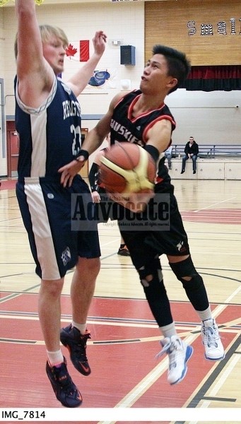Huskies senior boys John Survella makes a sweet underhand layup move for the basket in their exhibition game against Redwater.