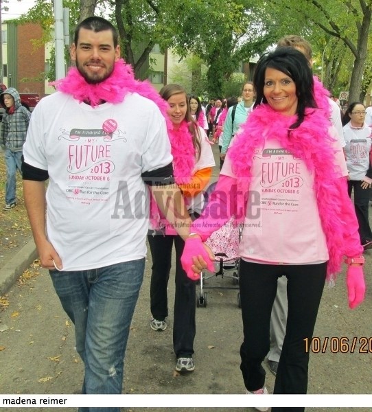 Madena Reimer (r), pictured walking with her son Jeremy during the 2013 Run for the Cure in Edmonton, is one of 10 finalists in the &#8216;Most Loving Person in