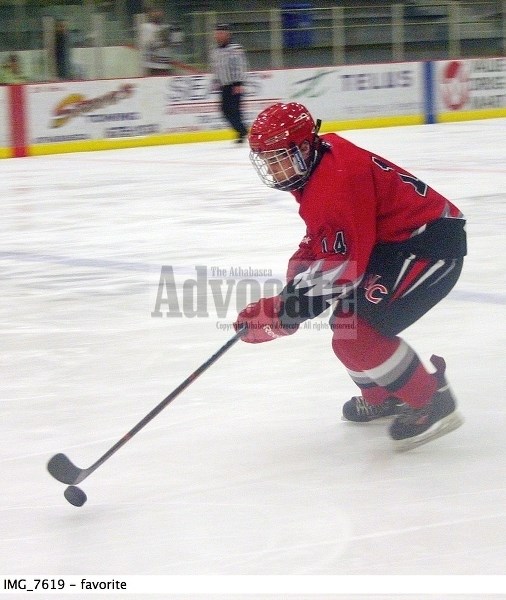 North Central Midget AA Bulls Lance Kotovich (14) brings the puck into the offensive zone during the second period of Saturday&#8217;s 7-1 loss to Beaumont at the Multiplex