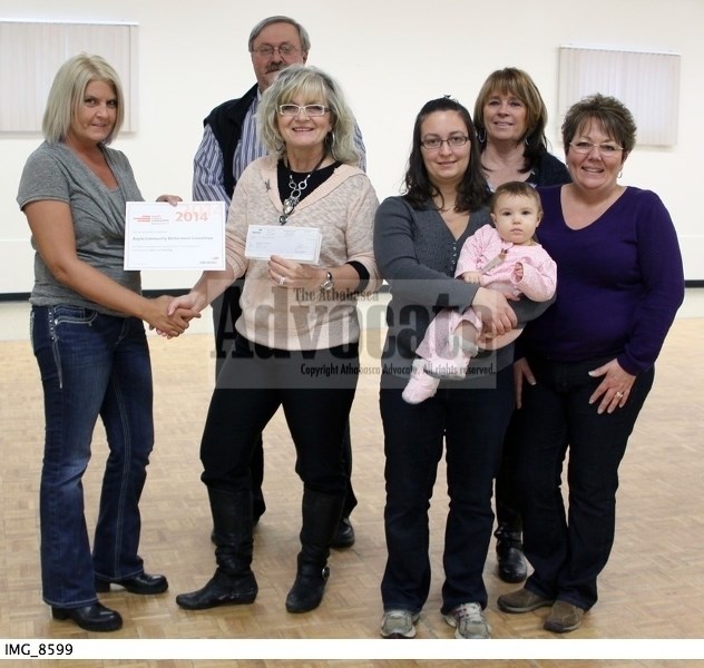 Devon Canada&#8217;s Tracey Thompson hands over the $5,000 grant to project manager Terry Mudryk-Harbarenko and volunteers Charlie Ashbey, Lindsey Stanton (with her daughter