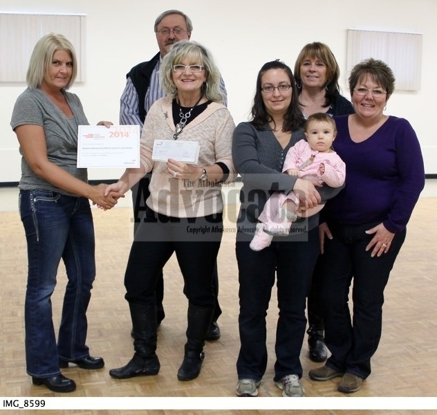 Devon Canada&#8217;s Tracey Thompson hands over the $5,000 grant to project manager Terry Mudryk-Harbarenko and volunteers Charlie Ashbey, Lindsey Stanton (with her daughter