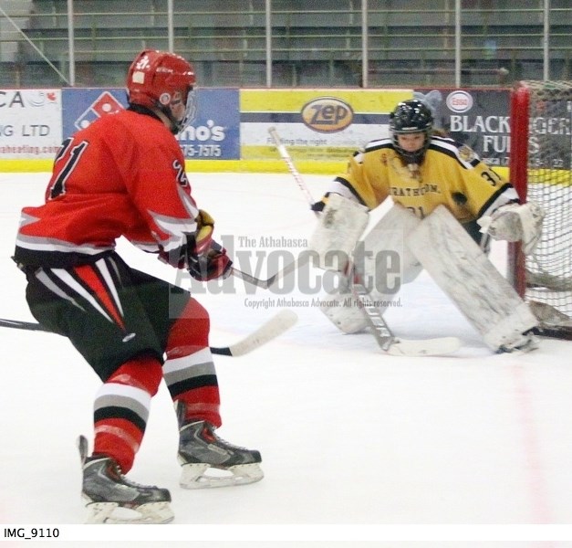 North Central AA Bulls Zach Bendall fires a backhand at the Strathcona netminder that finds its way under the arm of the goaltender&#8217;s glove hand and into the back of