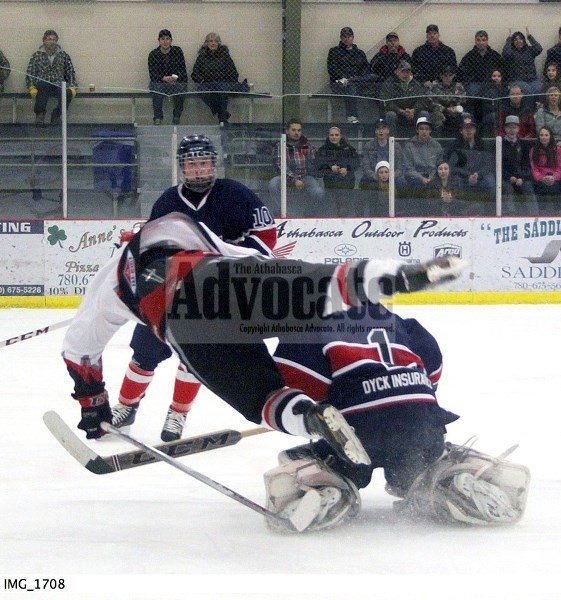 North Central Bulls Alvin Halter goes up and over the Wetaskiwin goaltender after he went after a loose puck near the top of the faceoff circle in the second period. Halter