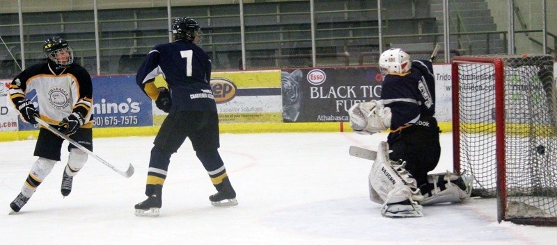 Jayce Matson watches his shot get behind the Edson goalie for the Hawks opening goal Saturday.