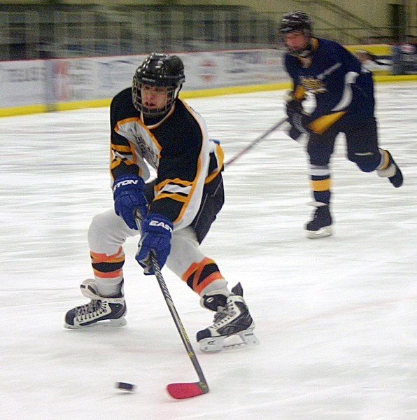Hawks Joshua Payuk drive toward the Edson net during Friday&#8217;s opening game of the final at the Multiplex.