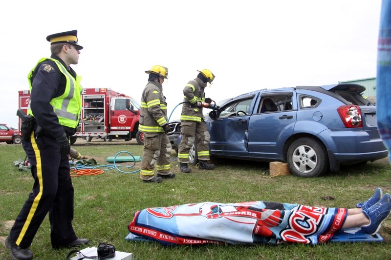 Boyle RCMP Cst. Dan Wegner oversees the scene of the reenactment of a two-vehicle collision involving an impaired driver, which includes a fatality, as members of the Boyle