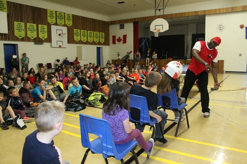 Olympic bobsledder Neville Wright helps students demonstrate how you lean into a turn, during a presentation at Rochester School last Monday.