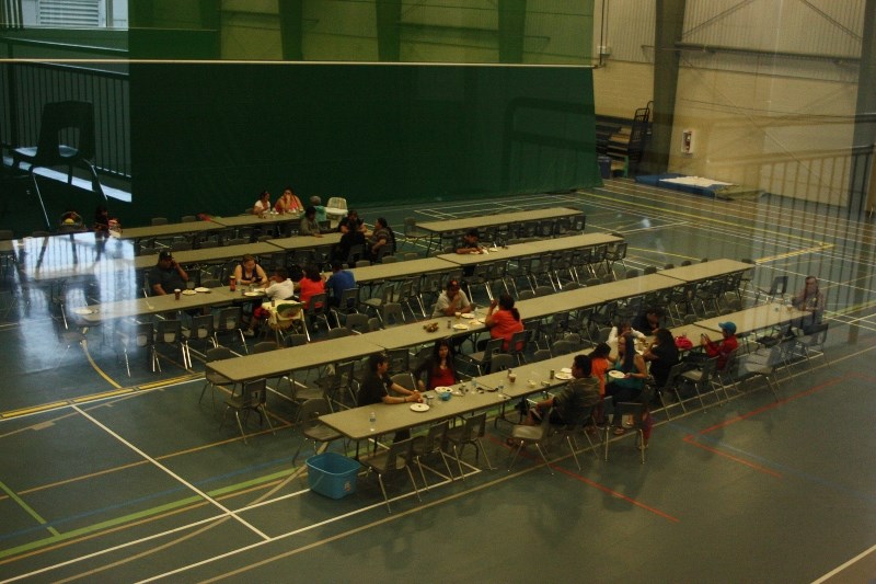 Wabasca evacuees eat lunch at the emergency reception centre in the Multiplex.