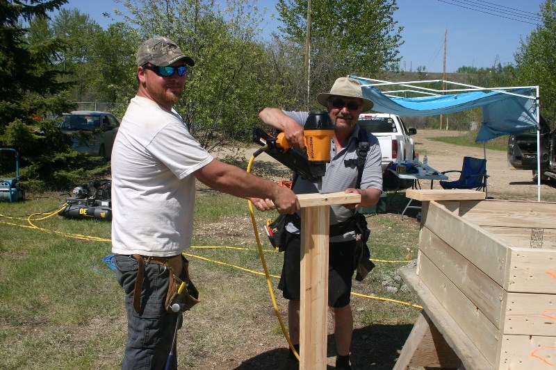 Luke Chrusch and John Kapelari put together some beds for the community garden.