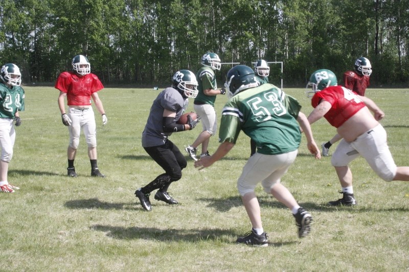 EPC Pacer Cole Ghostkeeper tries to outwit a couple of would-be tacklers.