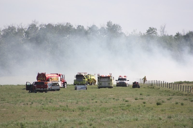 Crews battle a blaze on Hwy 2 near Colinton on June 8. The cause is still unknown, but two other blazes broke out at the same time in Colinton and Pine Creek.