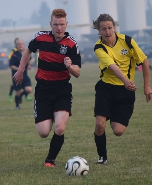 Athabasca U16 Titians FC, Shaun Funk, (left) chases the ball during a match against Olds. The Titans won the match 4-0 and would place fifth overall in the provincial