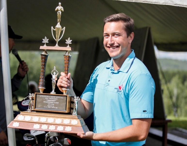 Mikkel Holt displays the Men&#8217;s Open Trophy after just receiving it from the scoring table. The 21-year-old shot a 147 after 36 holes of play.