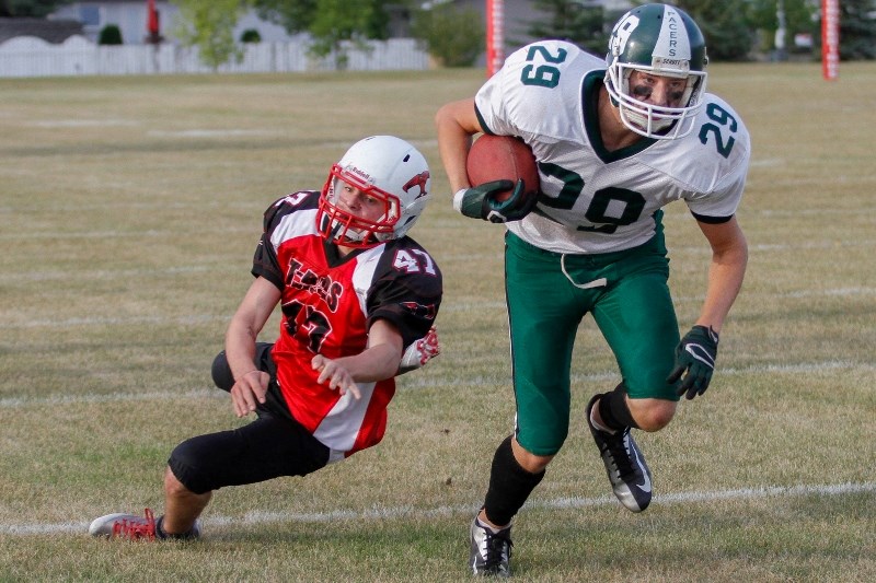 Adam Koons (29) beats the Westlock defender to get a first down at the 20 yd. line. The Pacers won the game in overtime 20-14.