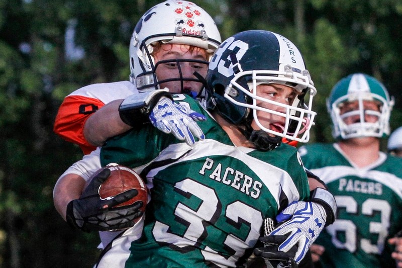 St. Paul&#8217;s Madison Brousseau evades Pacers defender, Rene Desjardins, during the third quarter of last week&#8217;s football game.