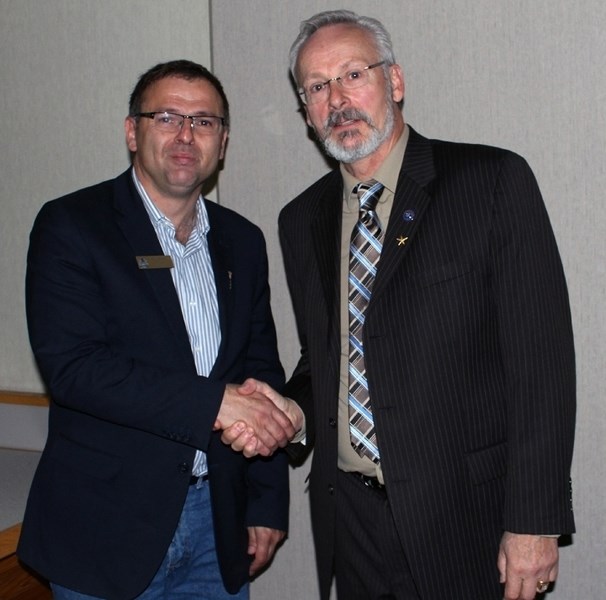 Athabasca-Sturgeon-Redwater MLA Colin Piquette (left) shakes Aspen View board chair Dennis MacNeil&#8217;s hand following Thursday&#8217;s school board meeting in which he