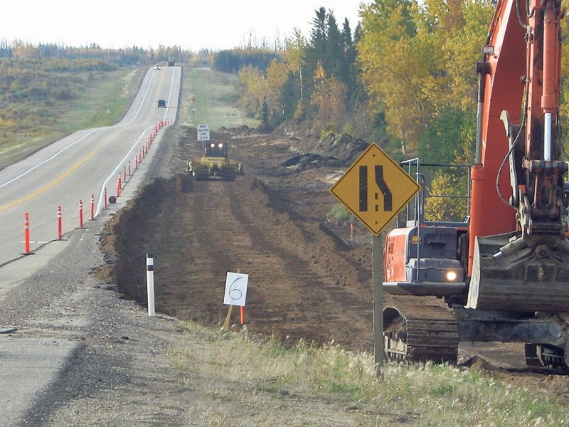 Construction crews work on twinning a section of Highway 63. The 16-kilometre stretch north of Mariana Lake officially opened on Oct. 19, a year ahead of schedule.