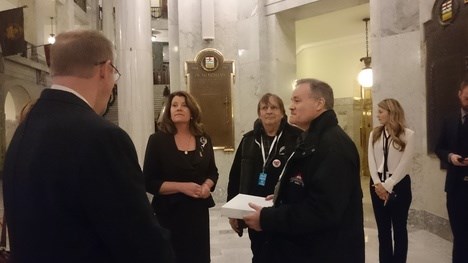Advanced education minister (second from left) Lori Sigurdson receives a petition to keep AU in Athabasca from AUPE, AUFA and CUPE reps on Nov. 25.