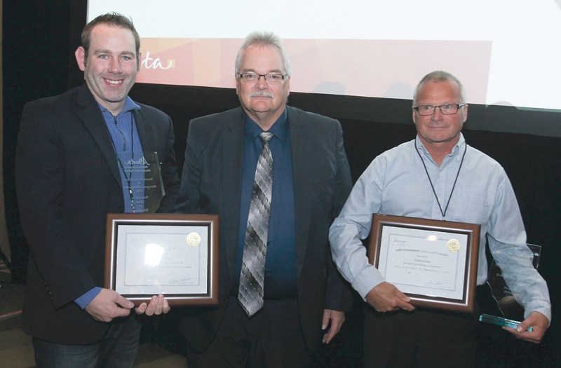 Alberta Municipal Affairs Deputy Minister Brad Pickering (centre) presents the Emergency Management Award to Town of Athabasca CAO Josh Pyrcz (left) and Athabasca County