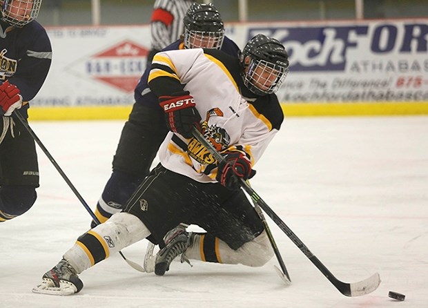 Elijah Anderson controls the puck while falling to his knees on an attempted breakaway in the first period. Anderson left the game with one assist helping the Hawks take the