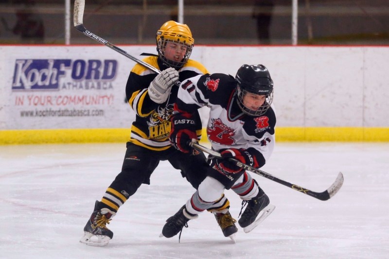 Athabasca Hawk, Jake Duncan and Boyle Blazer, Nicholas Bereziuk battle for puck possession during their first game on Jan. 16. Both teams faced off again in the finals with