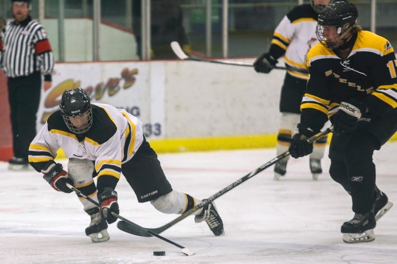 Bruce Jager try to keep control of the puck while rushing in the Barrhead zone. Jager had the Hawks fourth goal and game winner of the night as the team bested Barrhead 4-3.