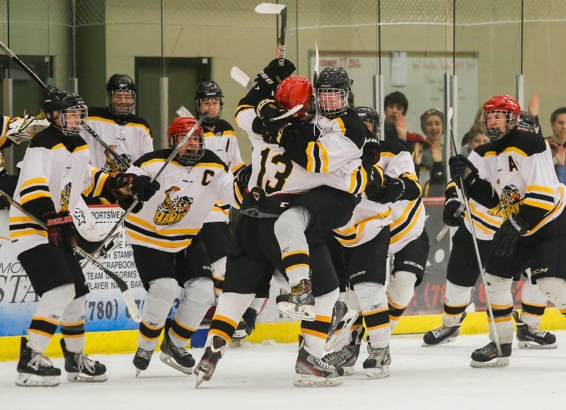 Shaun Funk jumps into the arms of Derek Greene after he scored the shootout winning goal to advance the Hawks to the second round of the 1660 Hockey League playoffs.