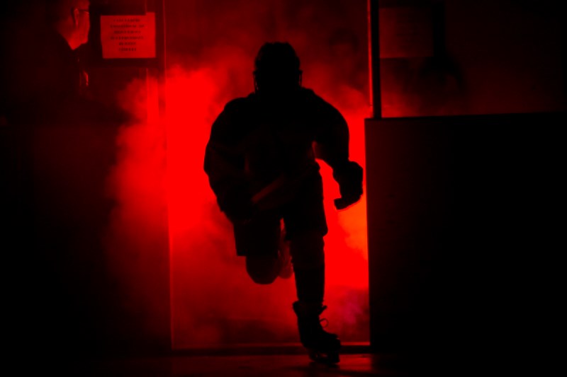 Karcyn Rodmanovich runs through the fog and skates onto the ice after being introduced to the crowd before the game against Manning.