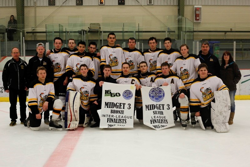 The Midget &#8216;A&#8217; Hawks gather around their newly acquired banner, after winning the bronze medal game during the 1660 Hockey league playoffs.