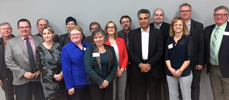 Human Services Minister Irfan Sabir (fifth from right) poses with representatives from local service providers and community groups. The Minister met with organizations on
