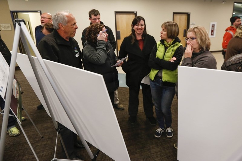 Pool committee head Rob Balay (left) answers questions about the two pool designs during the pool committee&#8217;s open house on March 10.