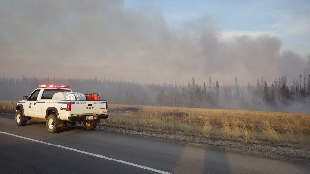 Wildland fire crews and air support battled a wildfire on Highway 63 near Atmore on April 18. Crews arrived around 7 p.m. Highway 63 was shut down for several hours and