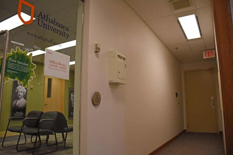 A hallway and locked door leads to a public budget meeting held at Athabasca University offices in Edmonton.