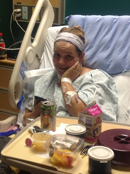 Jessica Dicks recovers in the hospital after blocking a falling tree with her body to protect her three children.
