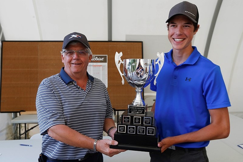 Cal Gilbart presents Treyton Tangedal with the Junior Open trophy after winning in a playoff against Jerrid Hanzel.